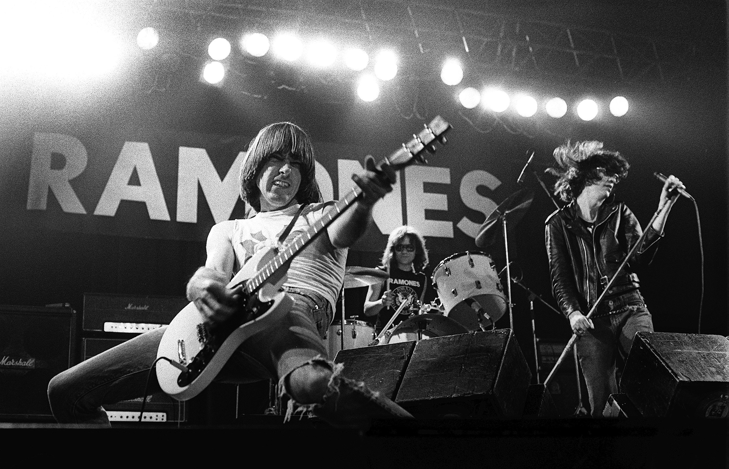 The Ramones at Manchester Apollo in Manchester, U.K., December 21, 1977. (left to right) Guitarist Johnny Ramone, drummer Tommy Ramone, and front man Joey Ramone. Photo by Howard Barlow/Redferns.